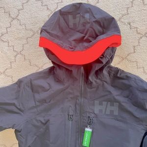 Brand new black men’s Helly Hansen Garibaldi insulated jacket w/neon hood trim.